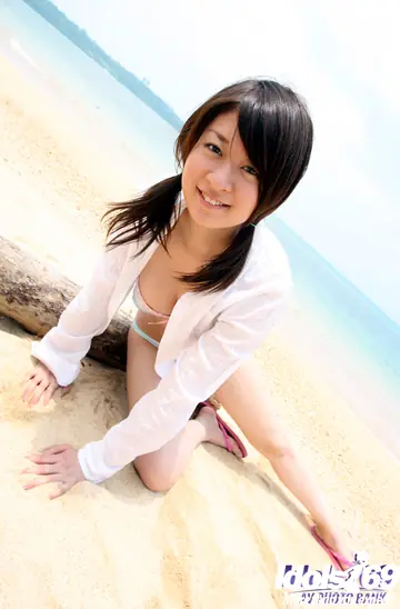 Japanese Brunette Strips Out of Her Panties on the Beach
