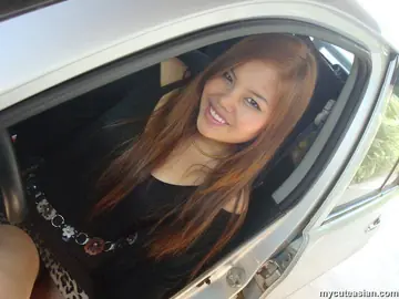 Busty Asian Redhead in a Skirt and Heels Spreads Outdoors