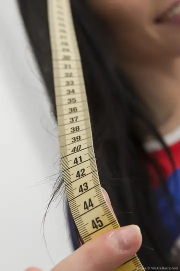 Petite Black-Haired Woman Fingers Her Hairy Pussy